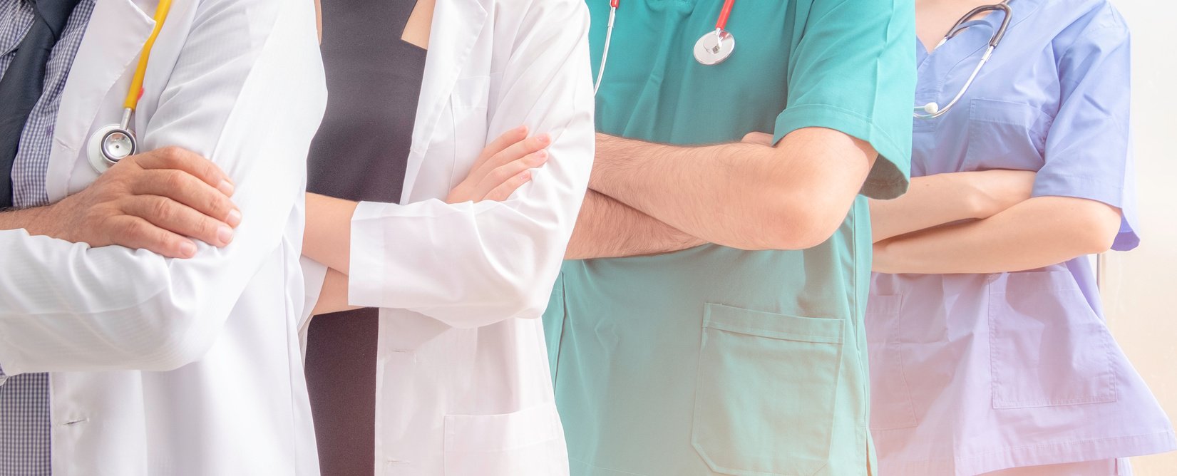 Doctors and nurses with uniform and stethoscope coordinate hands. Concept Teamwork in hospital for success work and trust in team